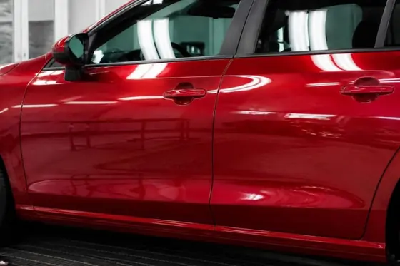 The same red doors with the dent removed and the paint refinished