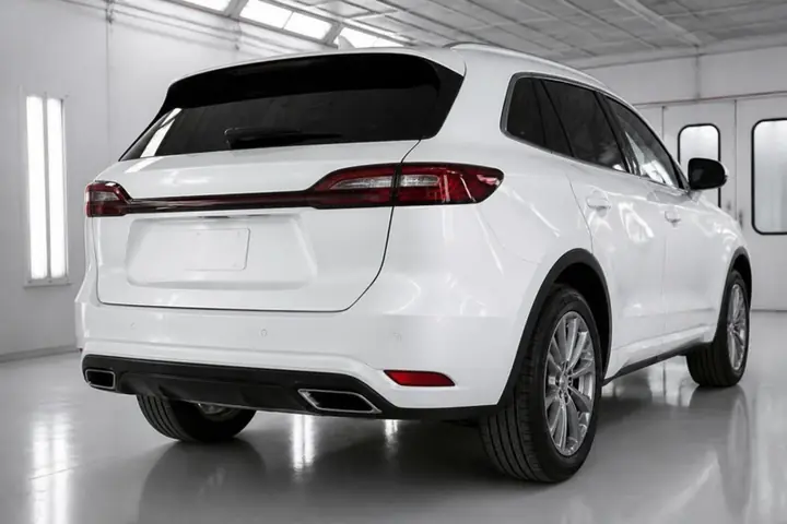 Pearl white SUV from the rear three-quarter with a clean, undamaged bumper