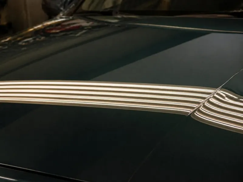 Dark green panel smooth after paintless dent repair
